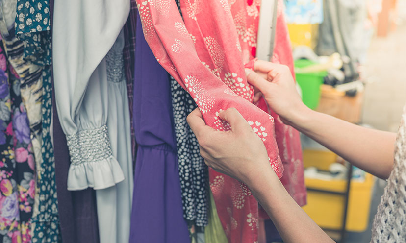 Woman's hands going through vintage dresses